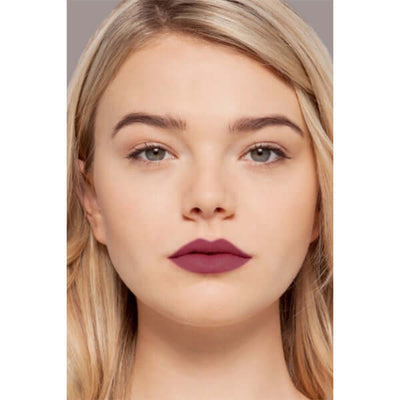 Charmed Plush Rush Satin Matte Lipstick (deep berry) on blonde model