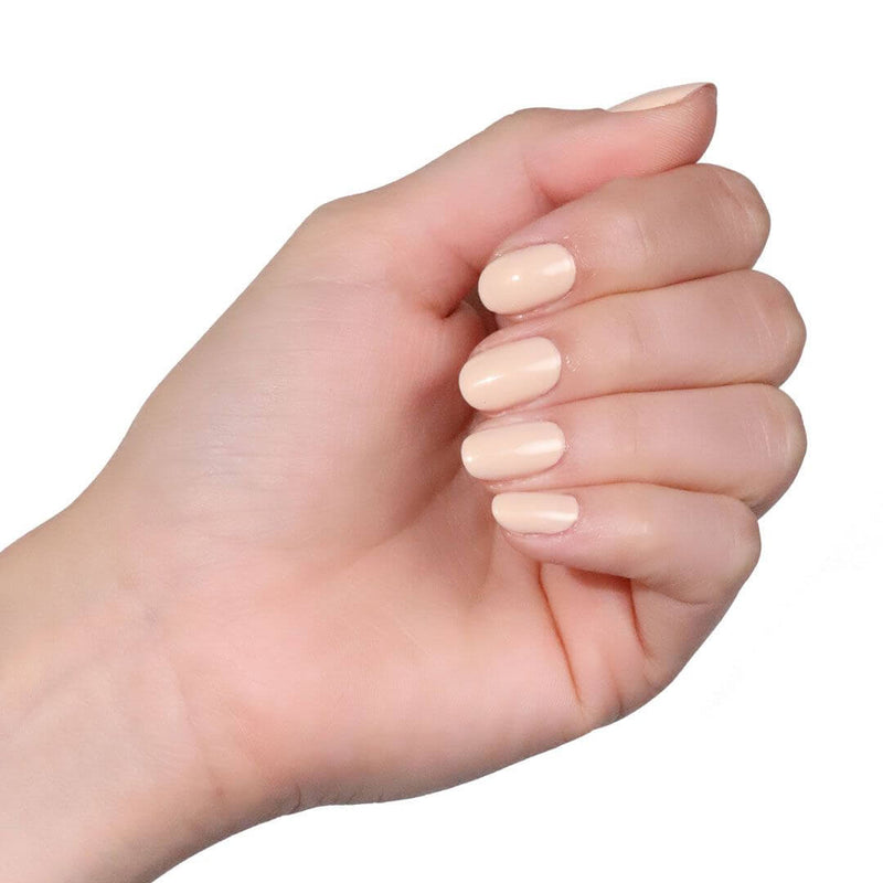 Folded hand, finger nails painted with High Street Crème Patent Shine 10X Nail Lacquer (Neutral Champagne crème with hints of gold) 